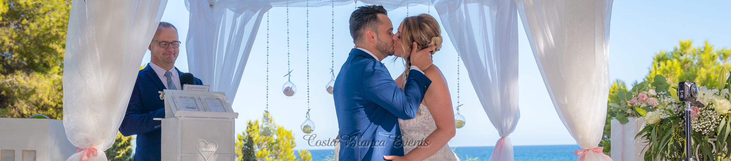 Bride and groom kissing during their ceremonial wedding in Spain